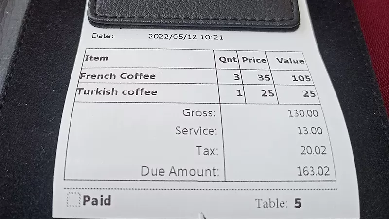 Some cafes include 15% VAT and tips in separate lines in the receipt, while others do not